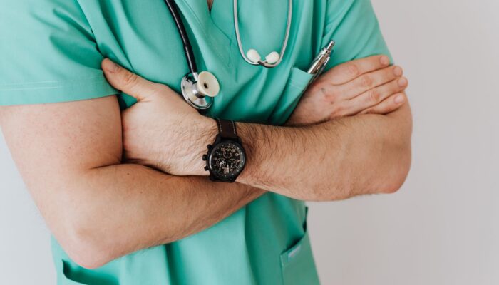 unrecognizable crop man in wristwatch with stethoscope