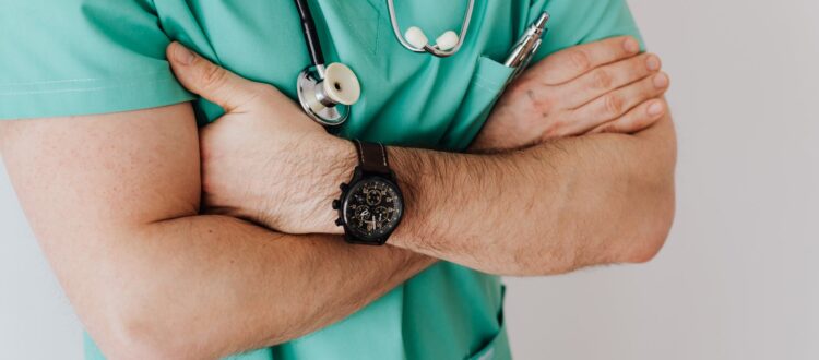unrecognizable crop man in wristwatch with stethoscope